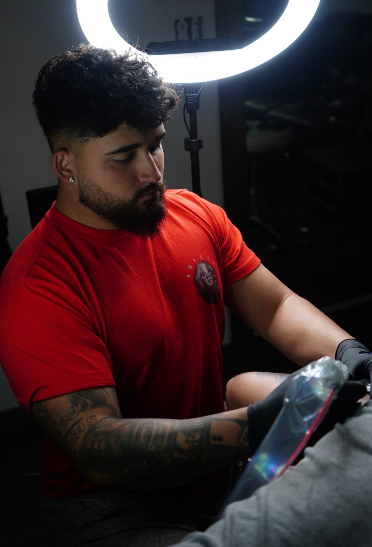 Tattoo artist at work in the studio