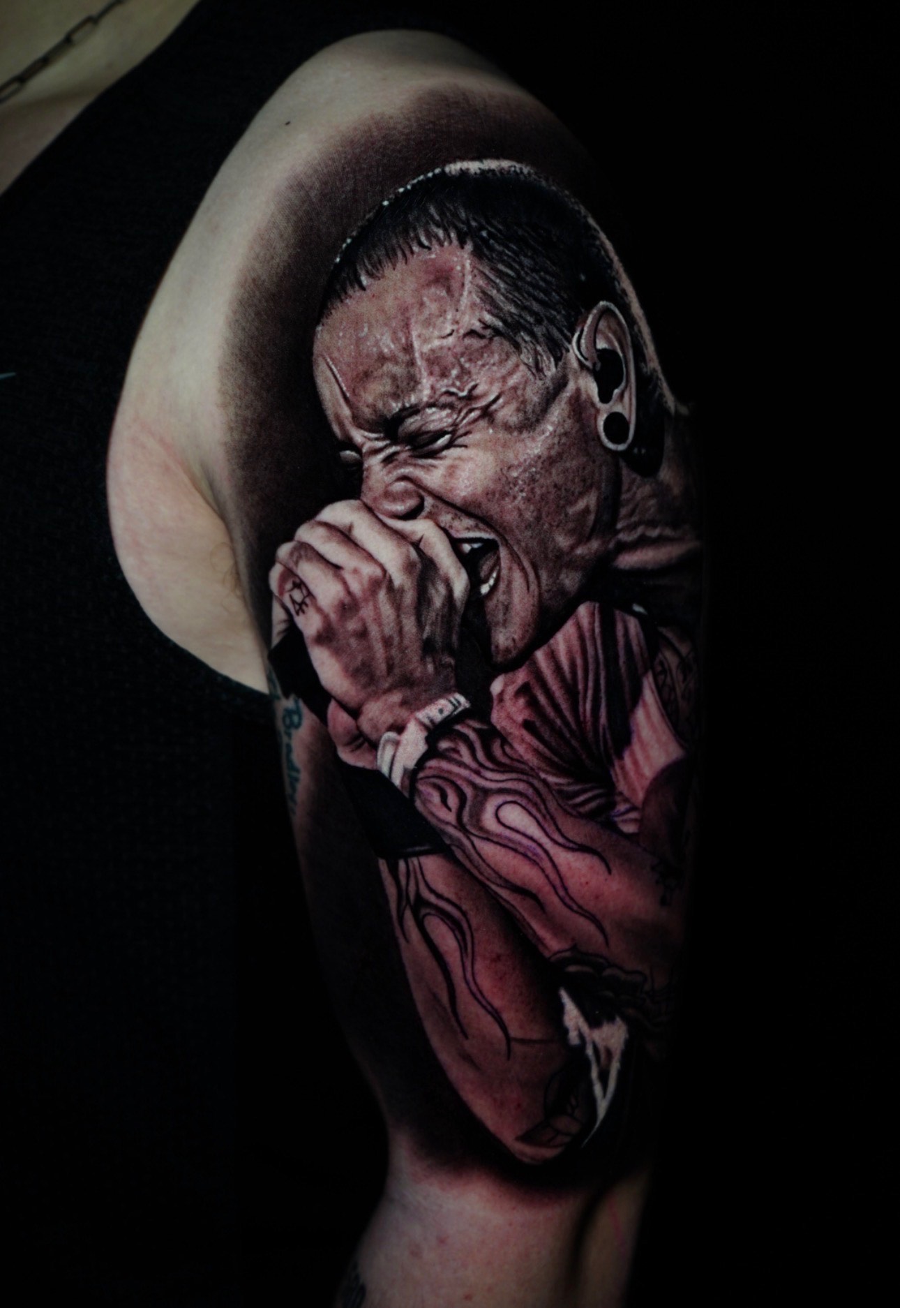 Realism tattoo of a vocalist singing into a microphone